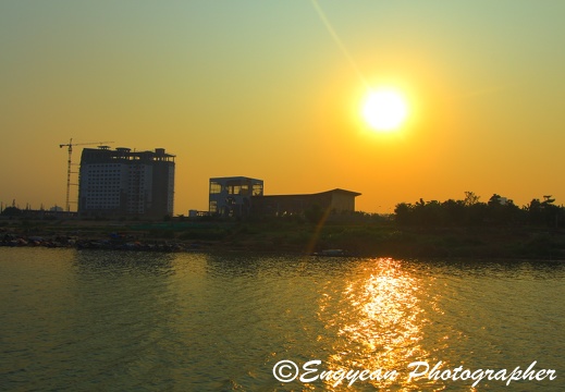 Sunset on the mekong river with sokha hotel under construction